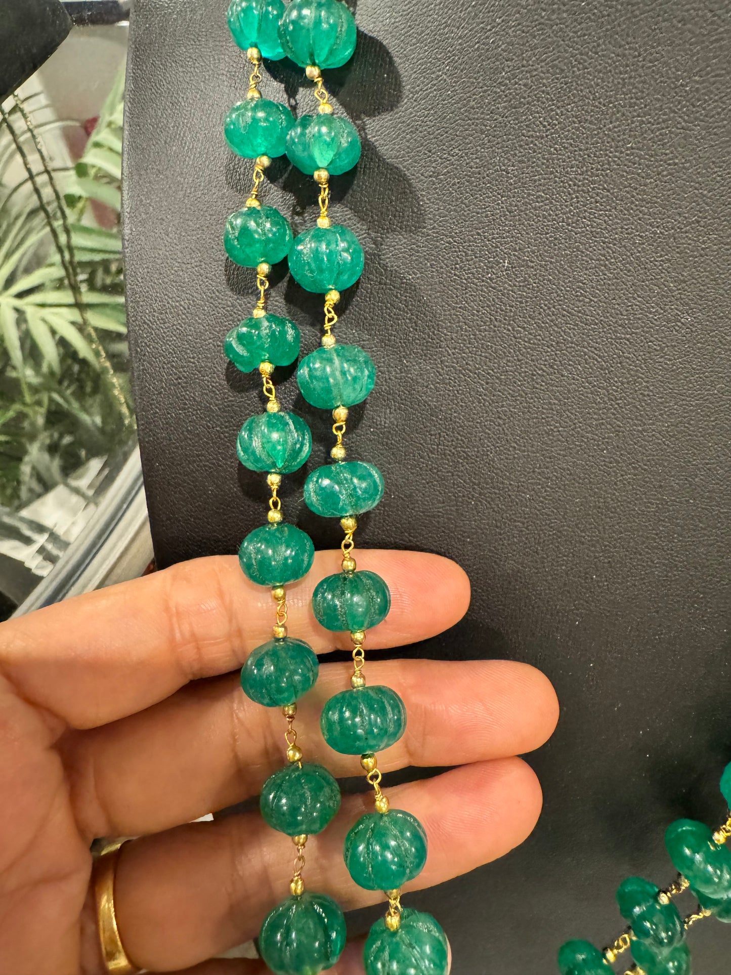 Emerald pumpkin carving in chain necklace