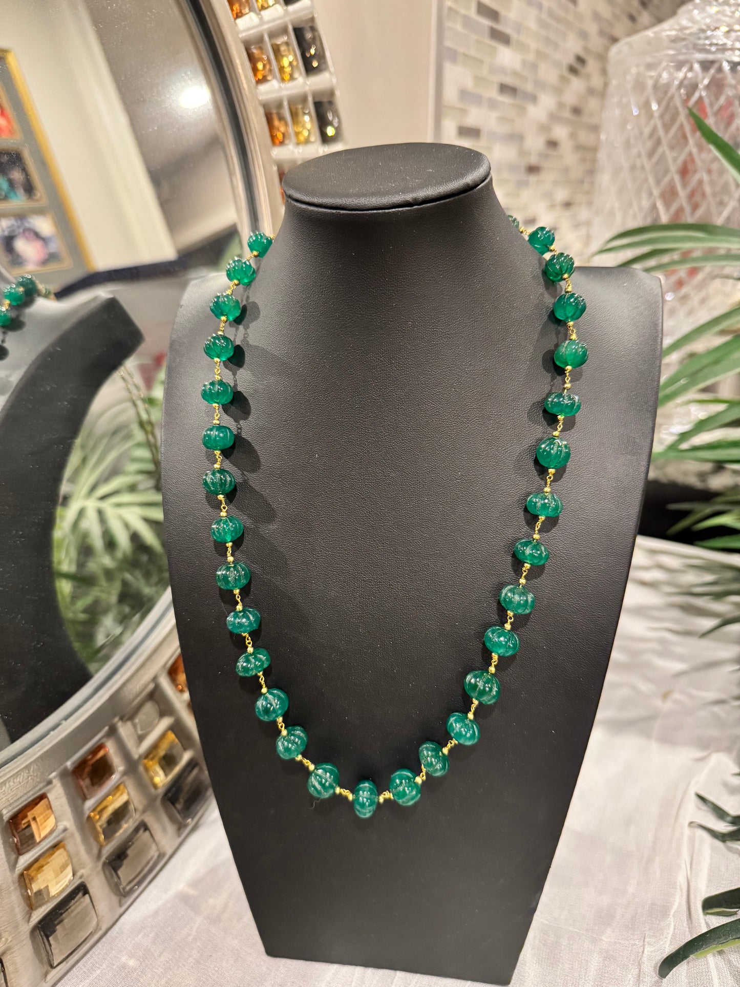 Emerald pumpkin carving in chain necklace